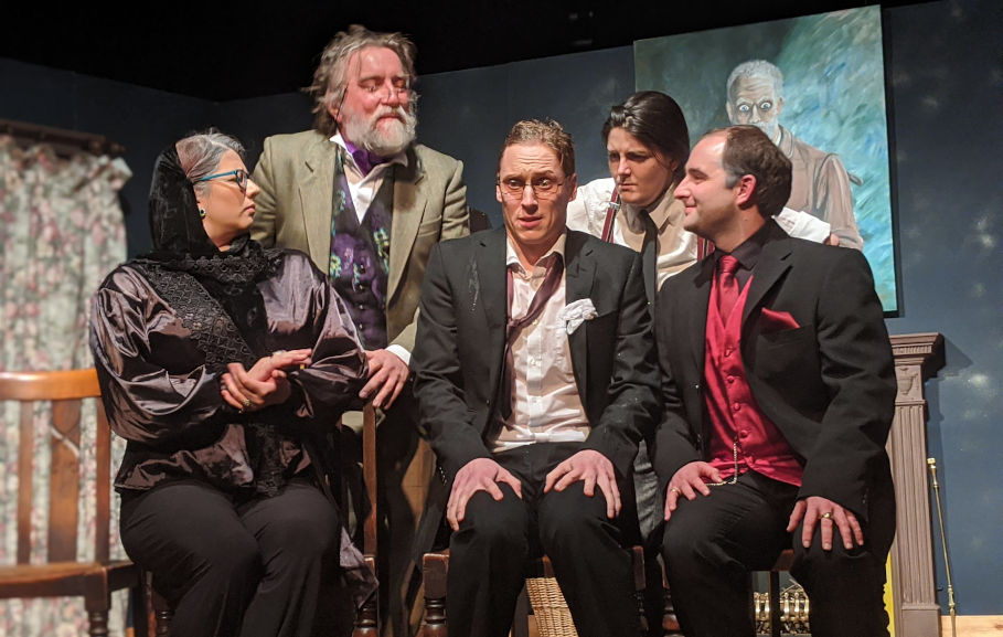 The cast of Peculiar Productions performance of Tomb with a View are on stage at Llanover Hall in Cardiff, performing a tense scene.